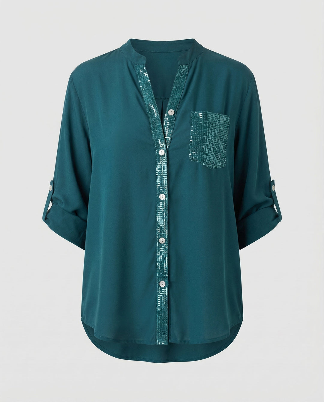 Sparkling blouse with rolled sleeves on a plain background.