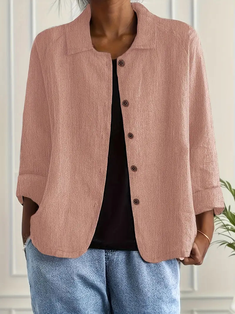  Female modelling a versatile long sleeve top on a plain background.