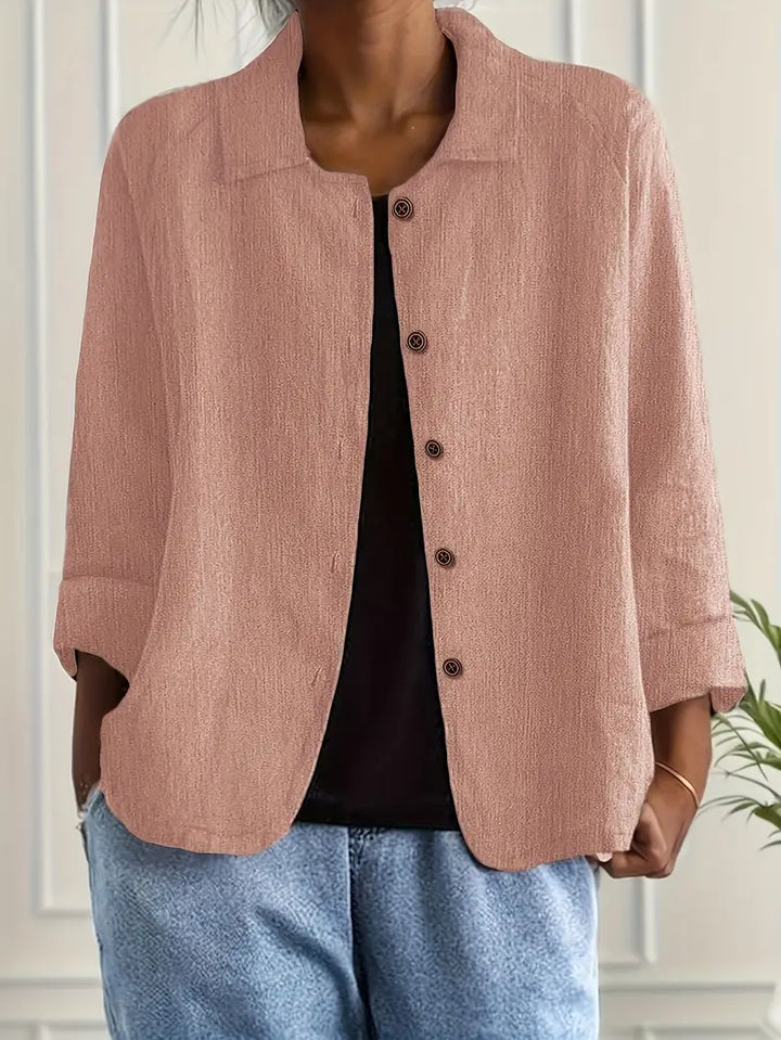  Female modelling a versatile long sleeve top on a plain background.