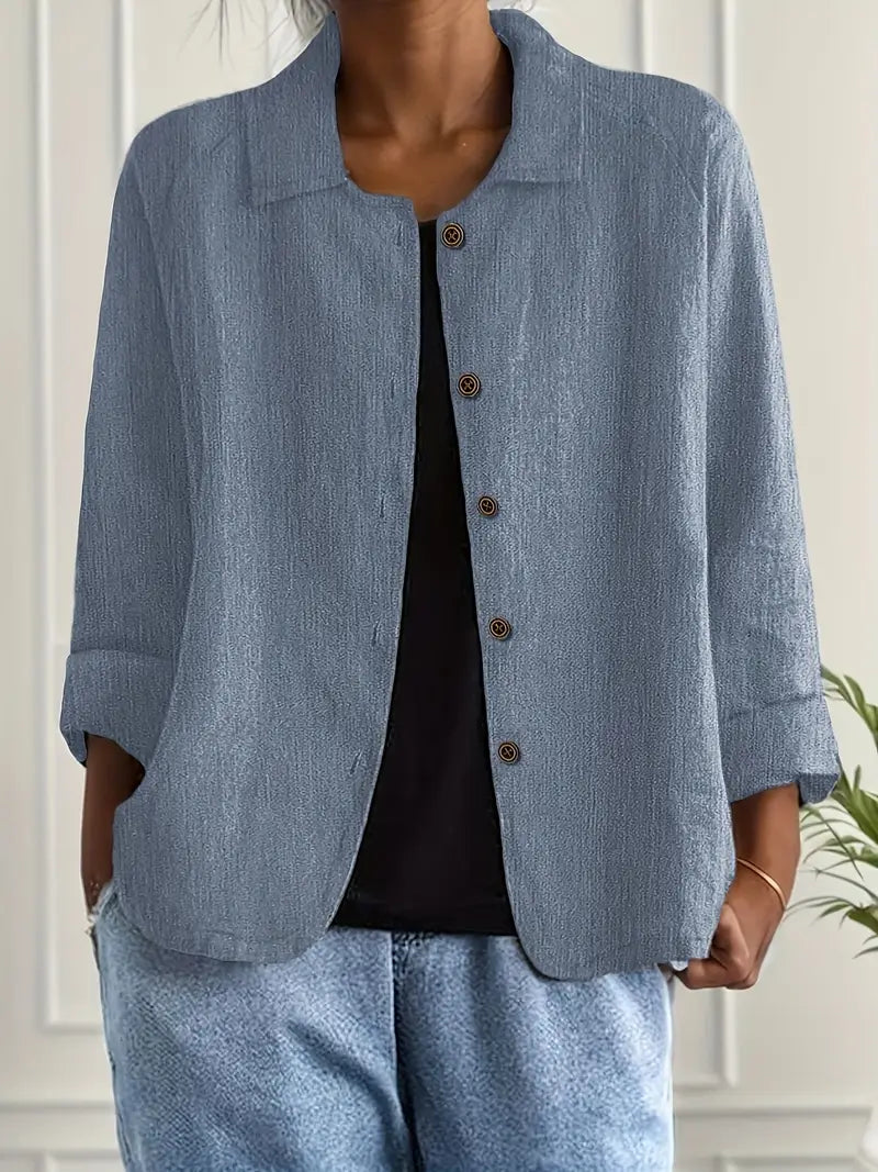  Female wearing a lightweight everyday top against a plain background.