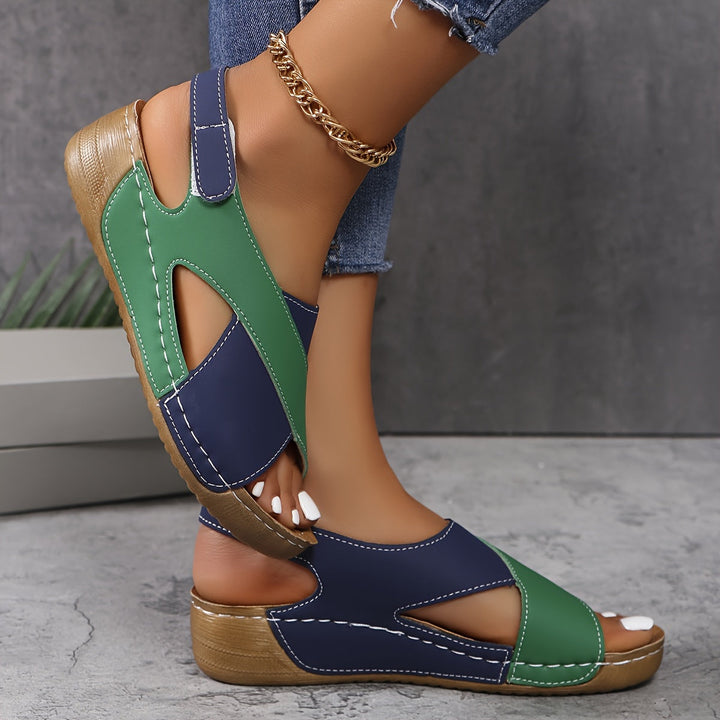 Female model wearing everyday walking sandals on a plain background.