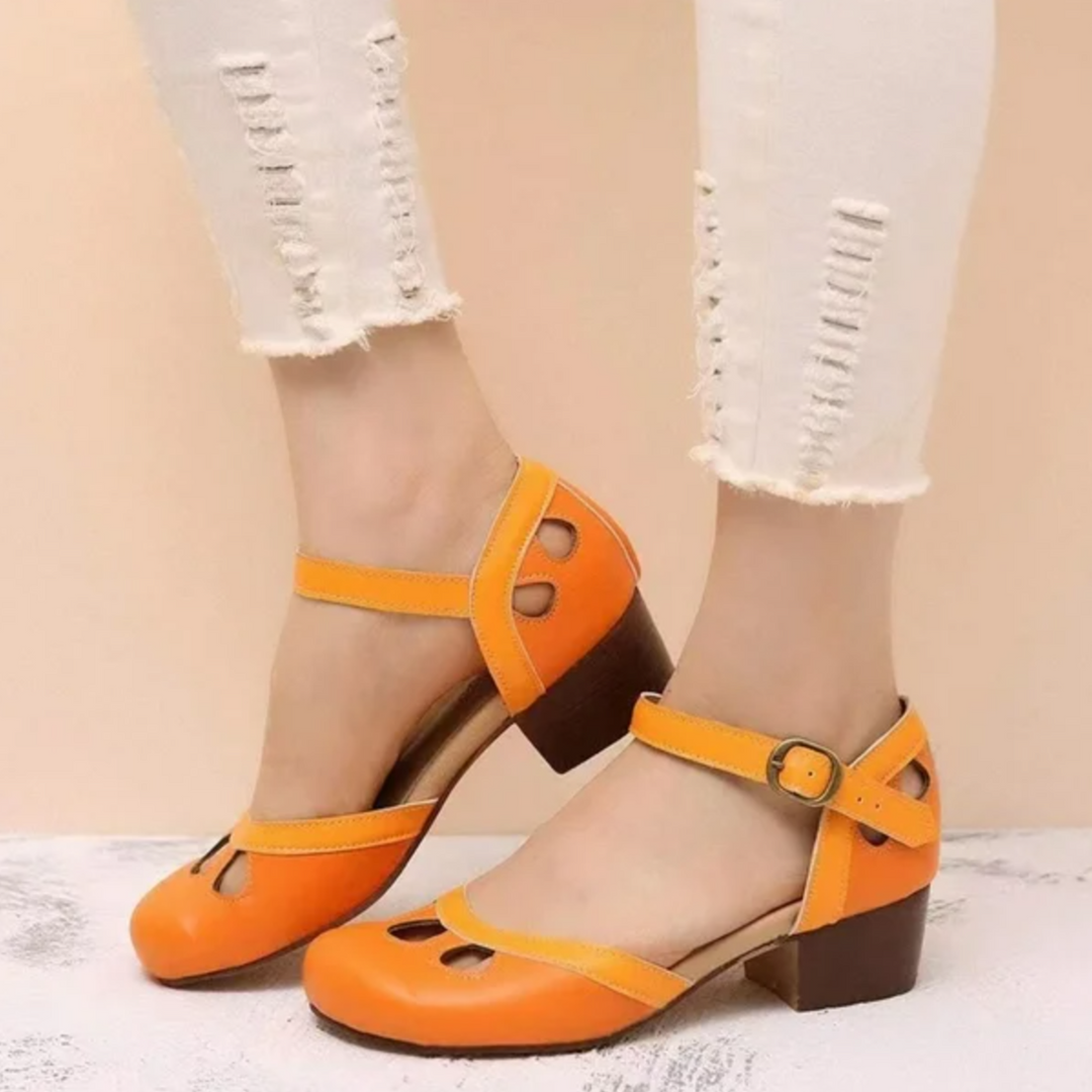Female model showing open-toe sandals on a plain background.