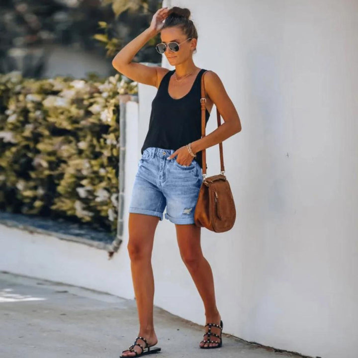 Female model wearing versatile high waist shorts designed for warm-weather outfits.
