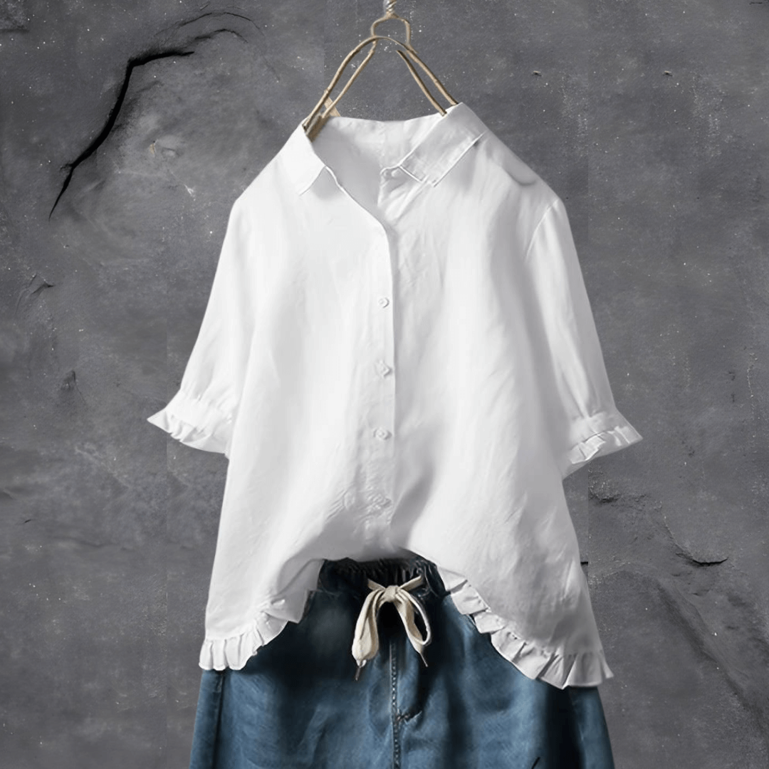  Female model showcasing a lightweight blouse with a clean design on a plain background.