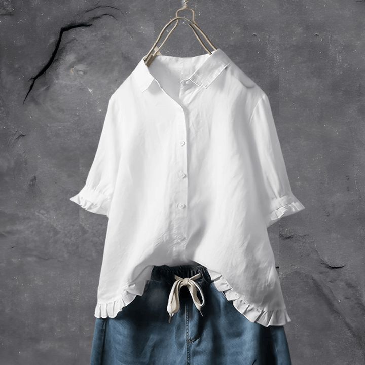  Female model showcasing a lightweight blouse with a clean design on a plain background.