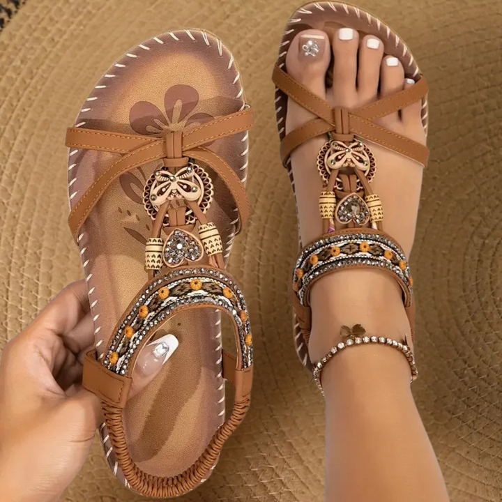 Woman wearing lightweight open toe sandals on a plain backdrop.