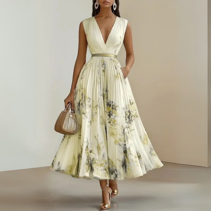 Woman modelling a sleeveless printed maxi dress with a flowing silhouette.