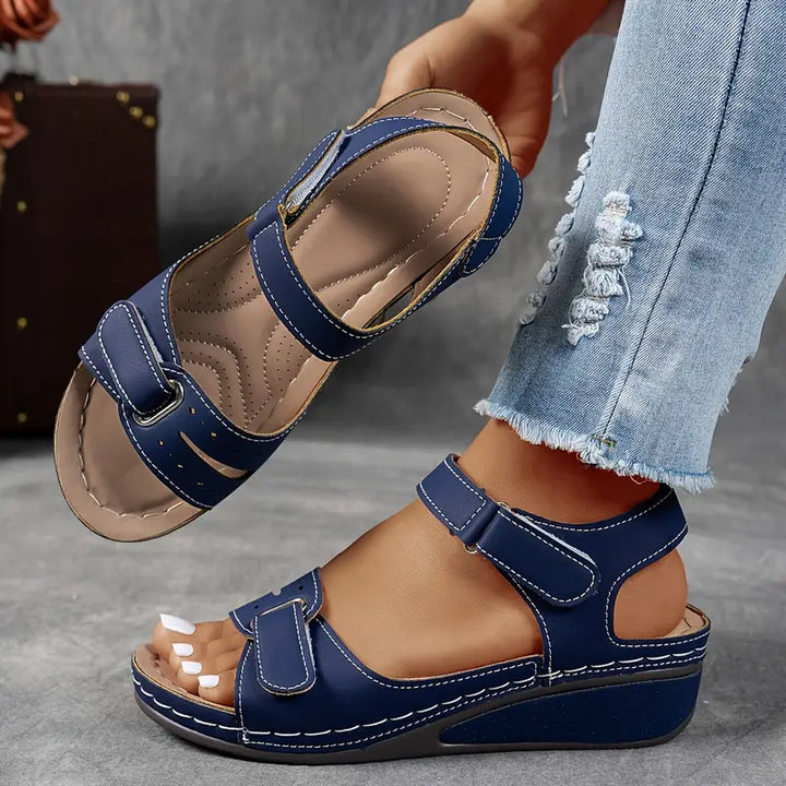 Female model wearing dressy casual sandals against a plain background.