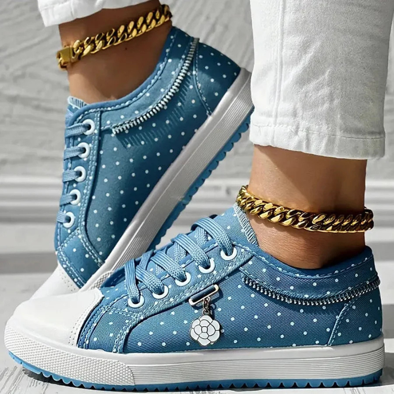  Woman showcasing lace-up trainers with a clean and timeless look on a plain background.