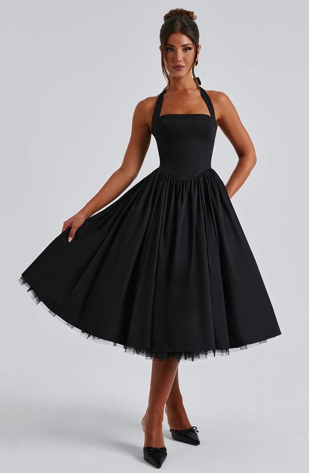 Model wearing a summer event midi dress with fitted bodice on a plain background.