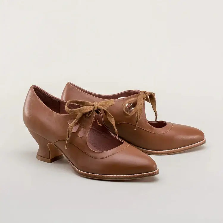 Graceful mid-heel shoes against a plain background.