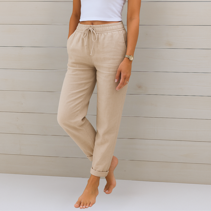 Female model wearing breathable elastic waist trousers against a plain background.