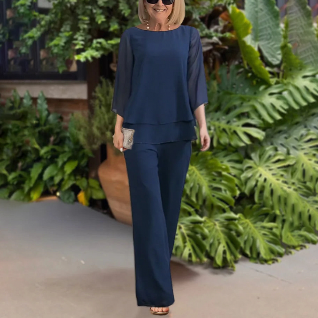 Female model wearing a summer two piece pants set on a nature background.