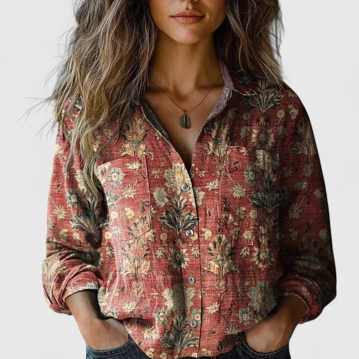 Female wearing a vintage floral button-down shirt against a plain background.