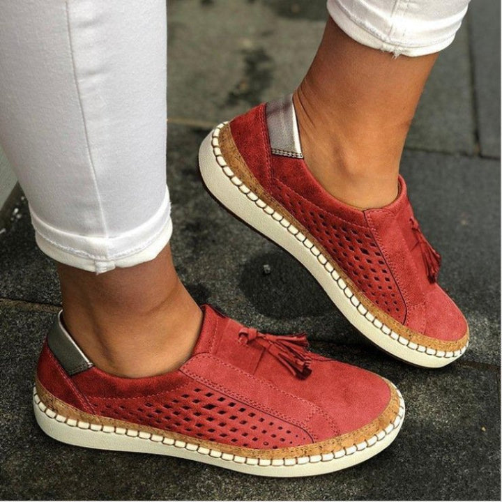 Model wearing modern open-toe slippers with textured sole on a plain background.