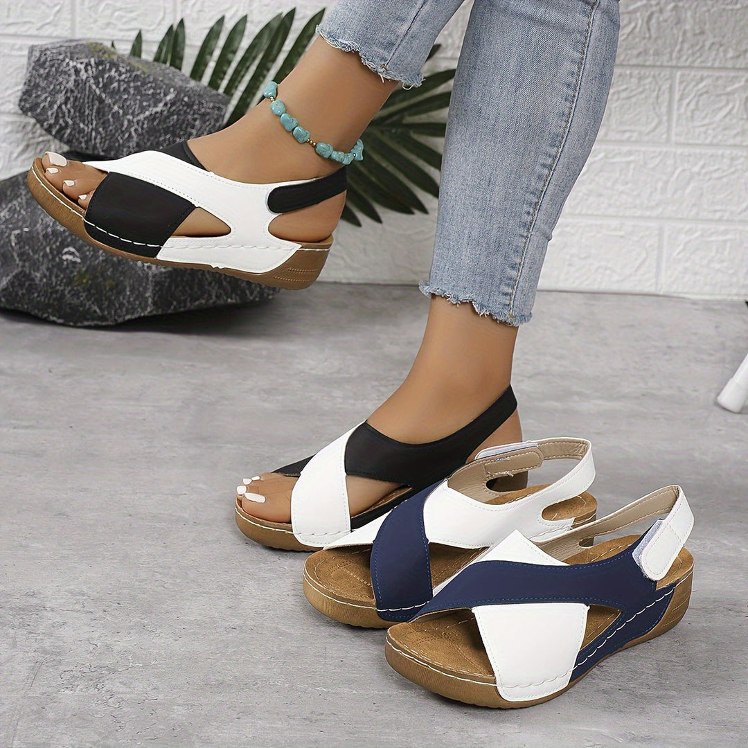 Female model wearing casual summer sandals on a plain background.