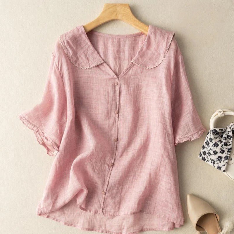 An elegant blouse with a scalloped collar and relaxed silhouette.