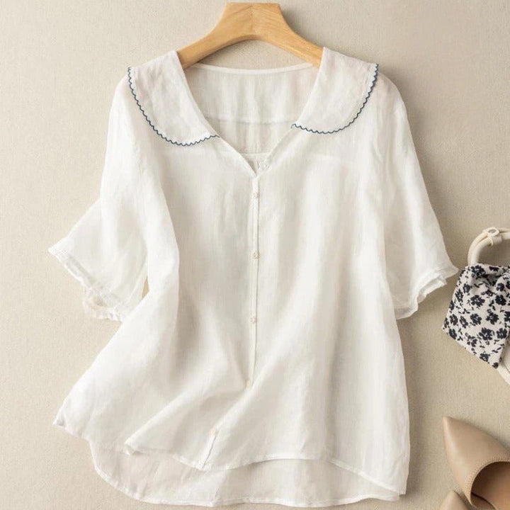 Classic blouse suitable for everyday wear on a plain background.