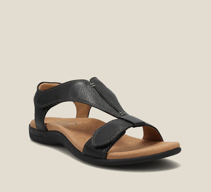 Cushioned sandals with a classic T-strap design on a plain background.