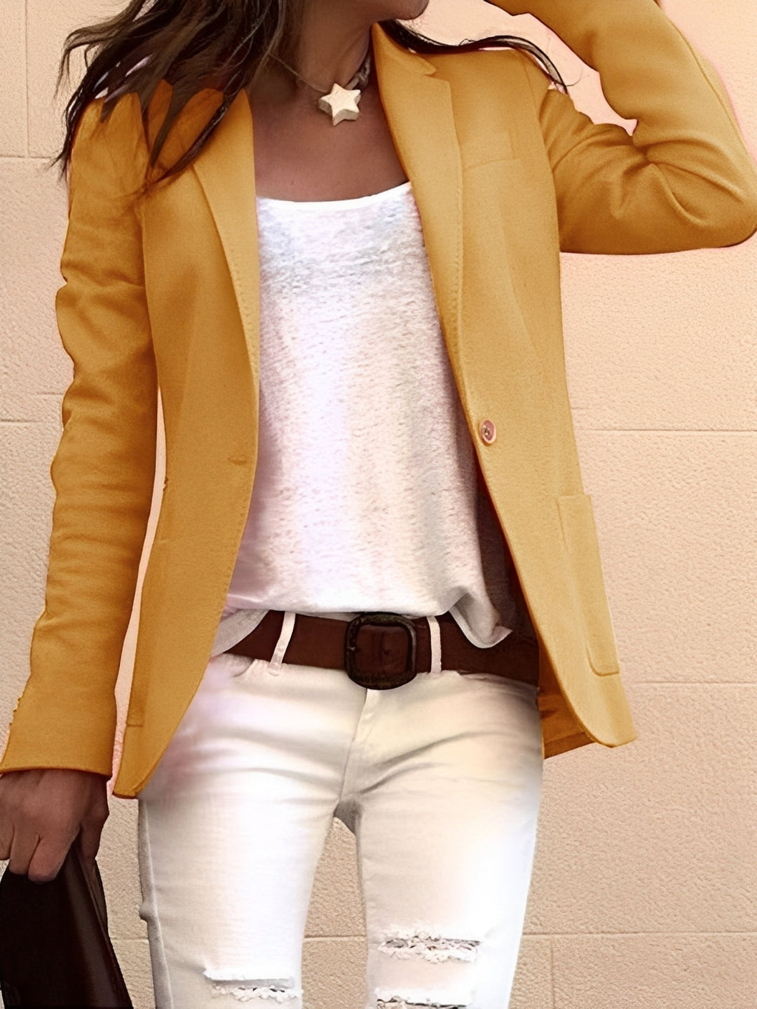  Woman wearing a structured slim fit blazer on a clean plain background.