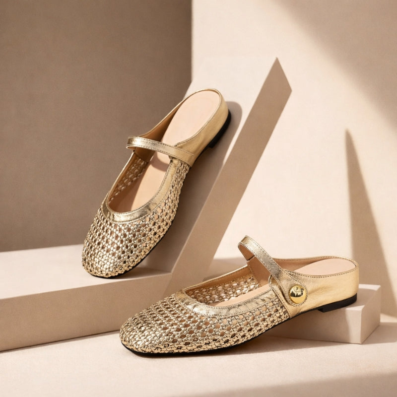 Open-weave flat shoes on a plain background.
