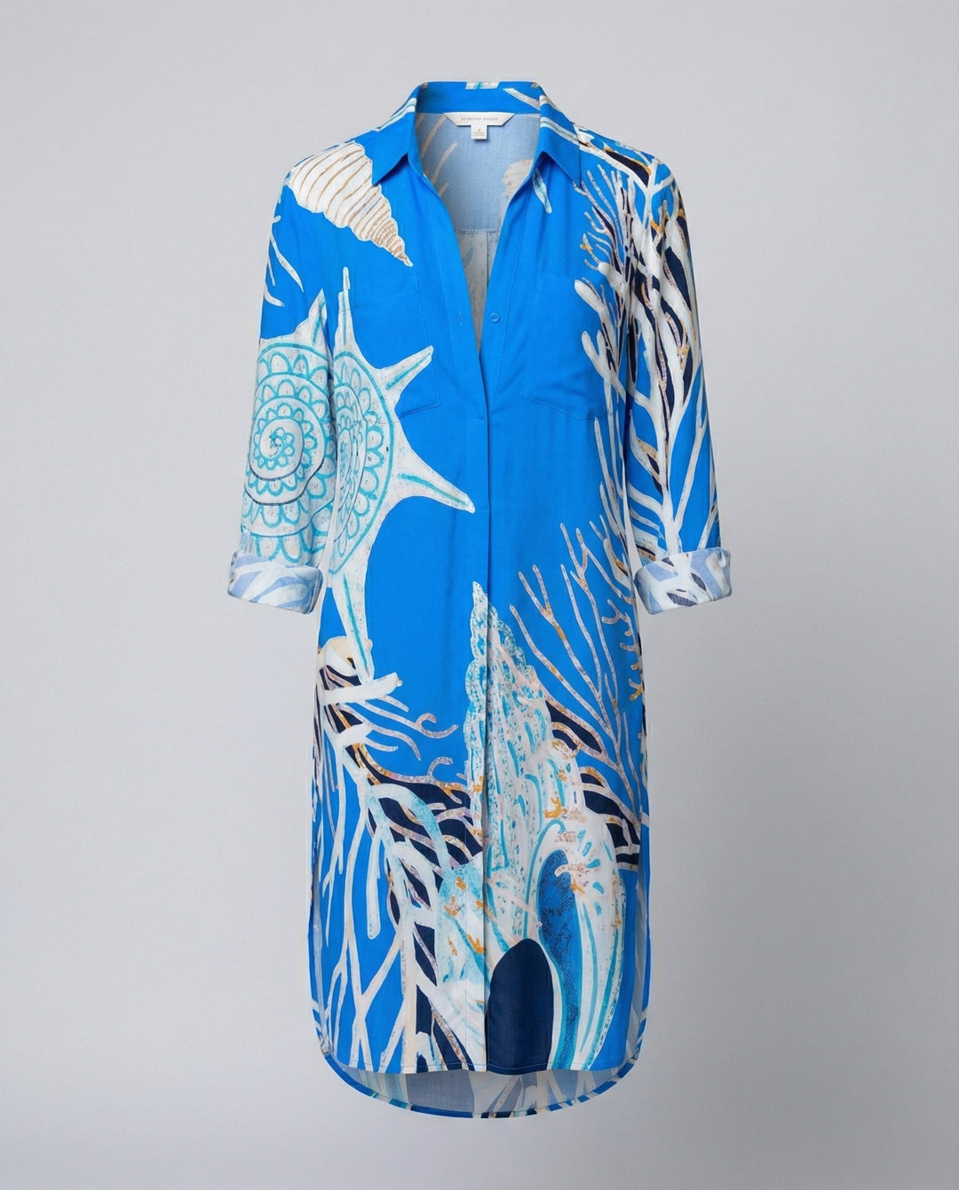 Woman in a lightweight long blouse with a nautical summer pattern.
