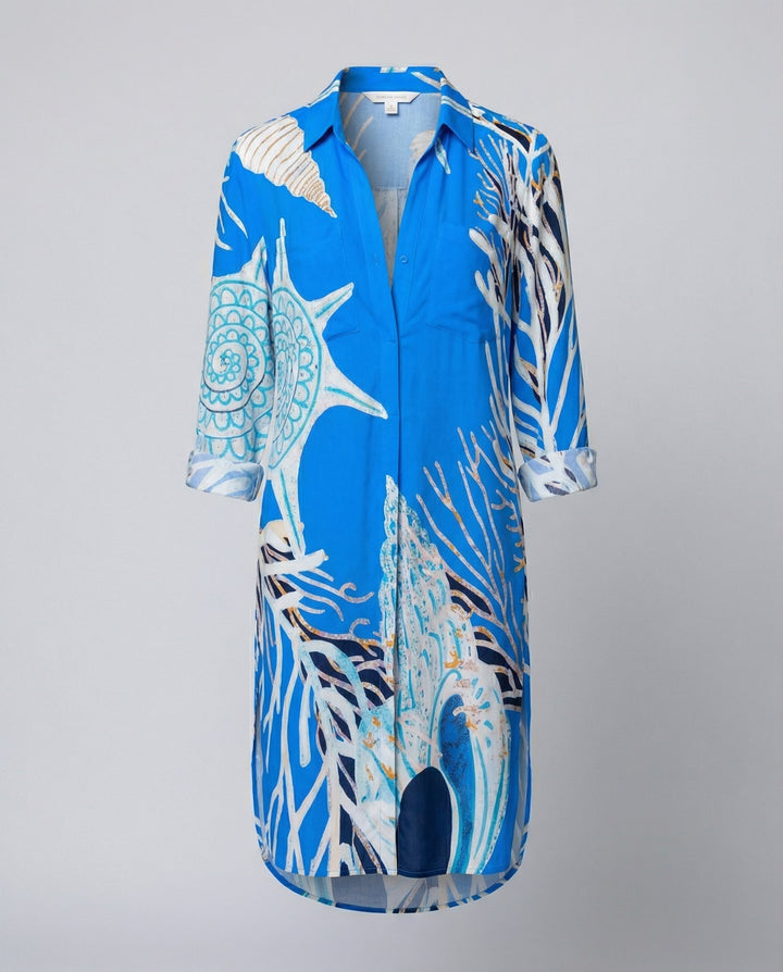 Woman in a lightweight long blouse with a nautical summer pattern.