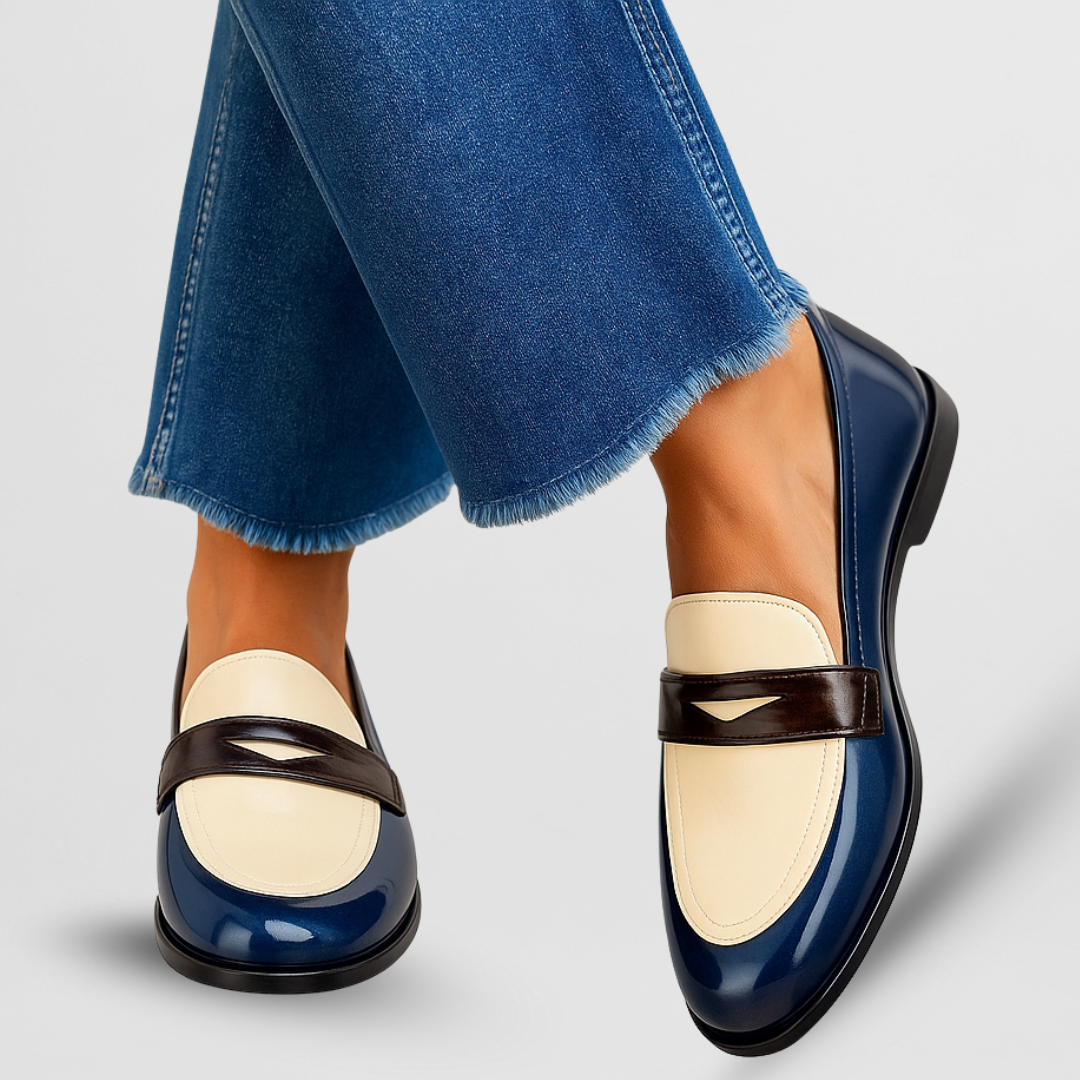 Woman wearing chic slip-on loafers on a plain background.