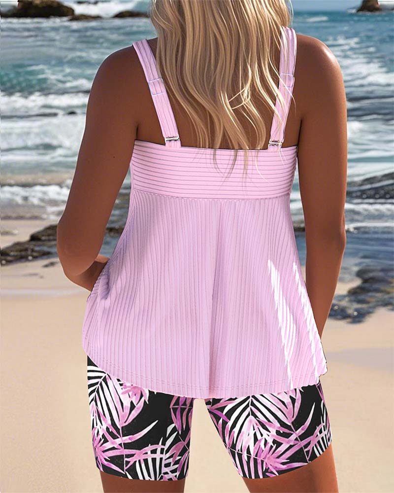 Female model in a printed swim top and high-waist bottom on a plain background.
