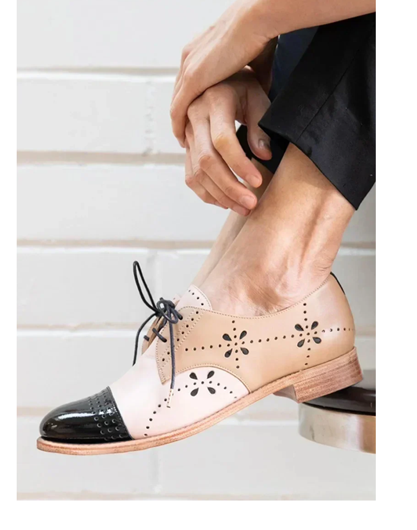 Two-tone women’s loafers displayed on a plain background.