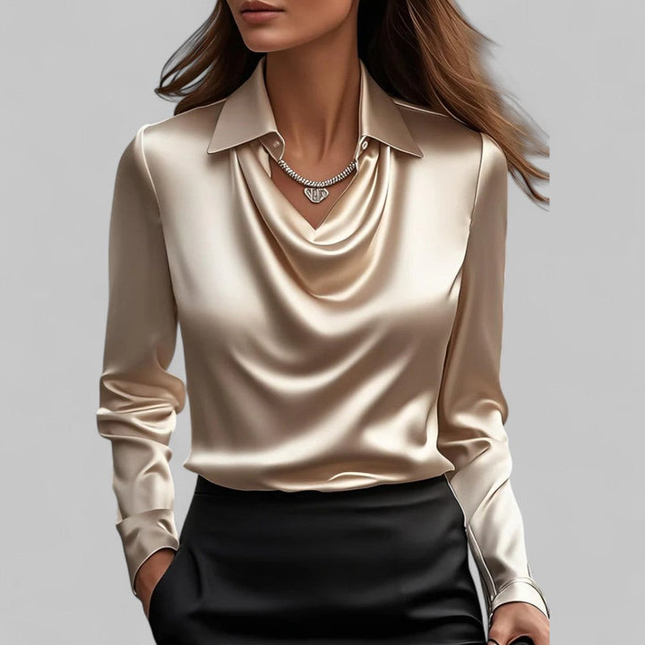 Female model styled in an elegant blouse with a soft neckline and relaxed silhouette.