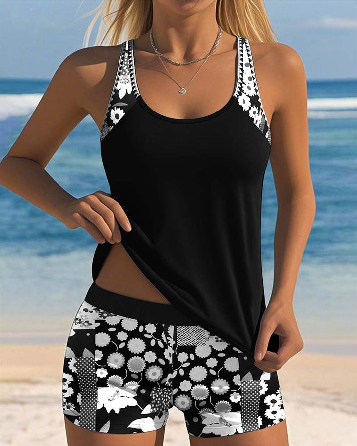 Woman in a summer floral tankini set with matching swim shorts on a beach background.