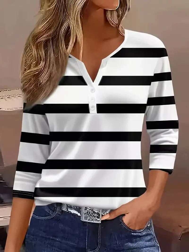  Woman in a horizontal striped top with three-quarter sleeve styling.