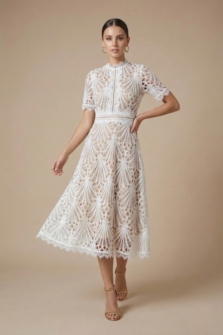 Female model wearing a scalloped hem midi dress with defined waist on a plain background.