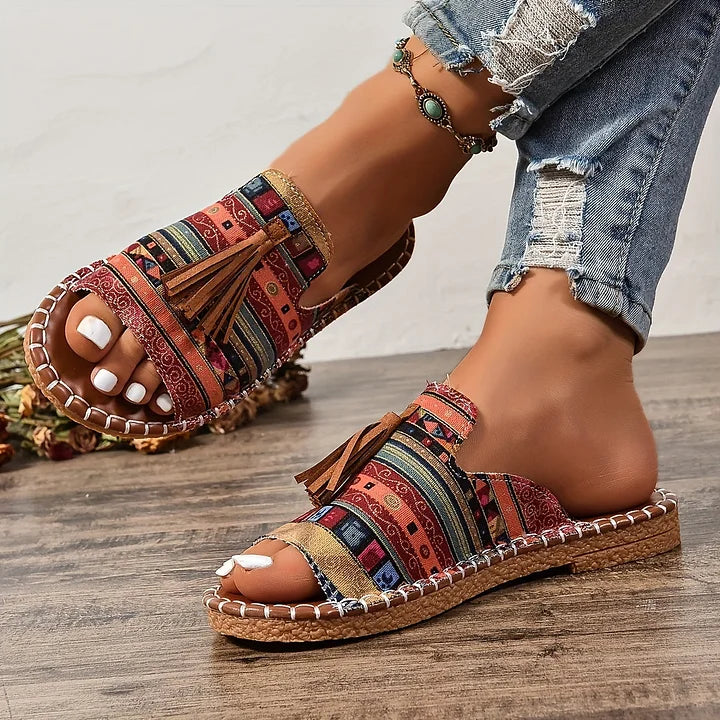 Woman showing slip-on sandals for everyday outfits against a plain background.