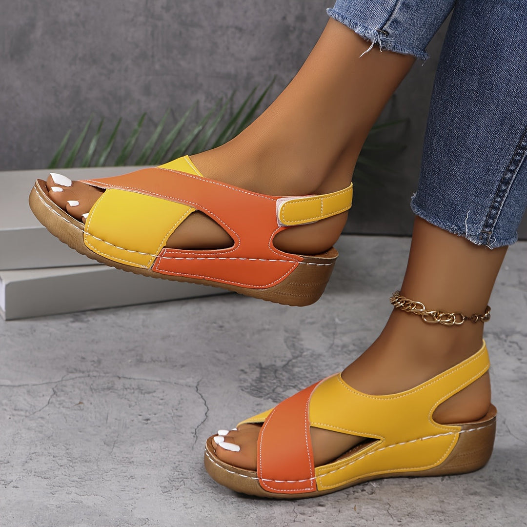 Woman showing summer sandals with a casual outfit on a plain background.