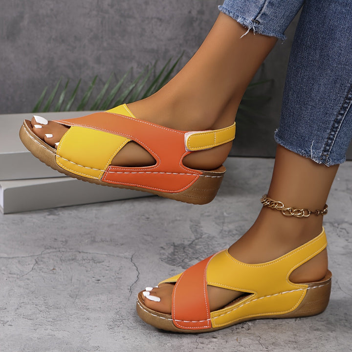 Woman showing summer sandals with a casual outfit on a plain background.