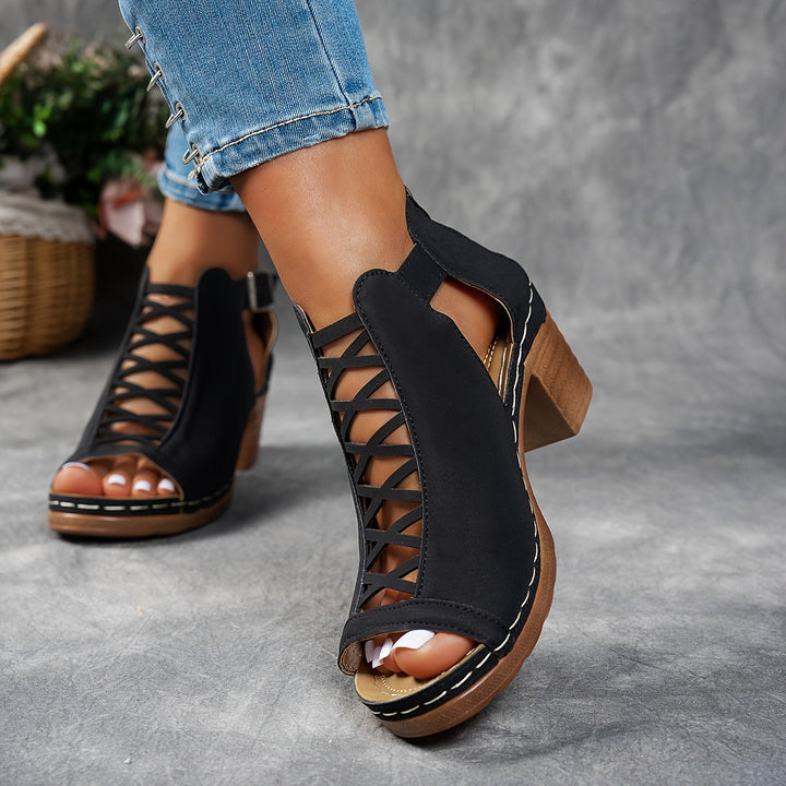 Woman showcasing cushioned sandals with a contemporary open-toe design.