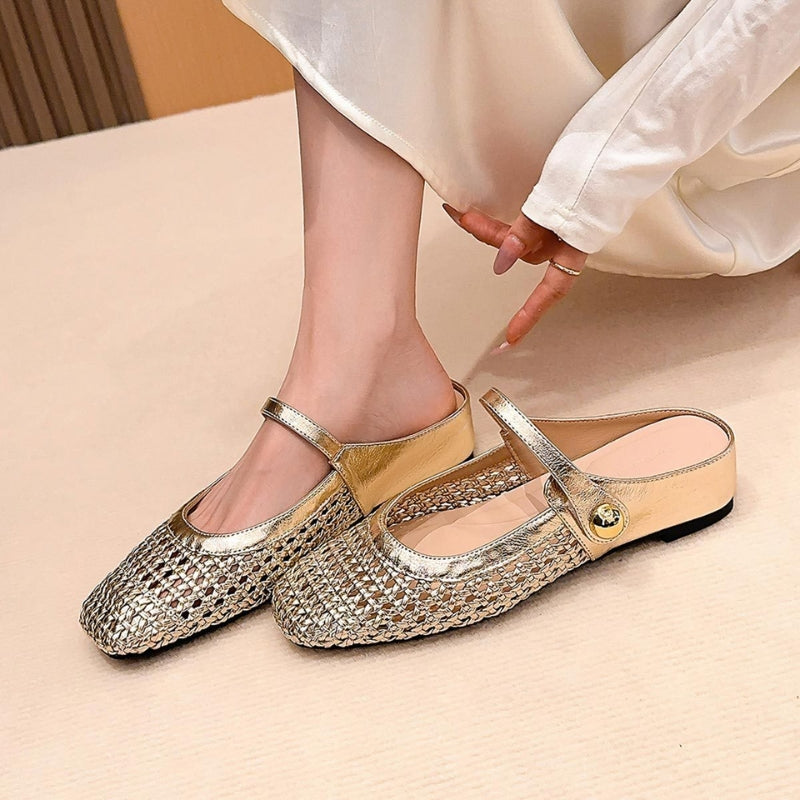 Woman wearing woven Mary Jane mule shoes on a plain background.