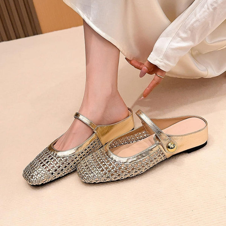 Woman wearing woven Mary Jane mule shoes on a plain background.