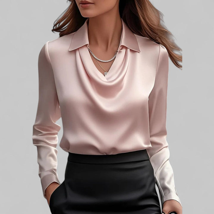  Female model showcasing a silky long sleeve blouse with a draped front design.