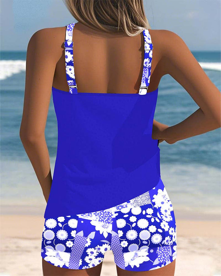 Female model wearing a beach-ready floral tankini set on a beach background.