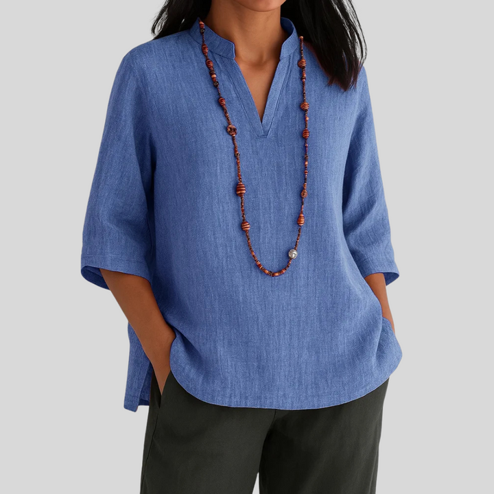  Woman modelling a loose-fitting blouse with a soft green colour.
