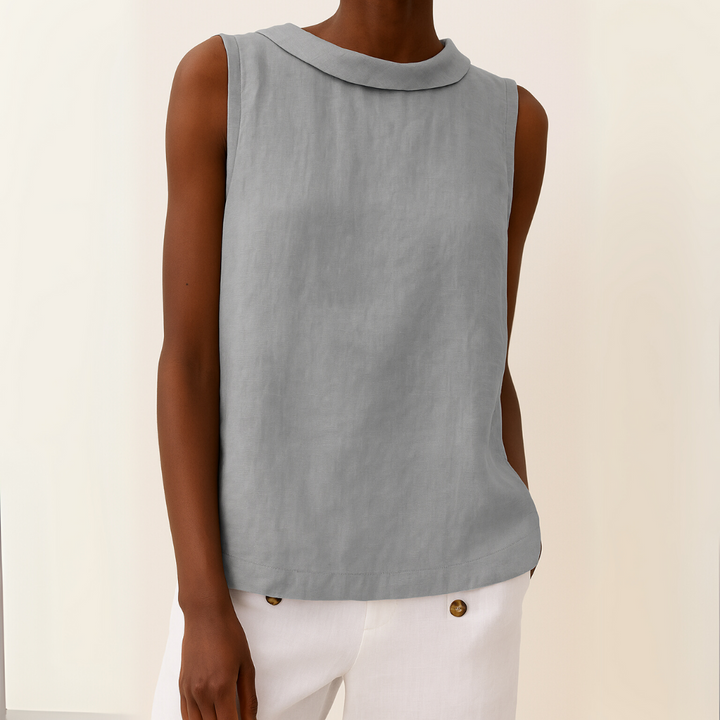 Female model wearing a sleeveless top with a rolled collar neckline against a plain background.