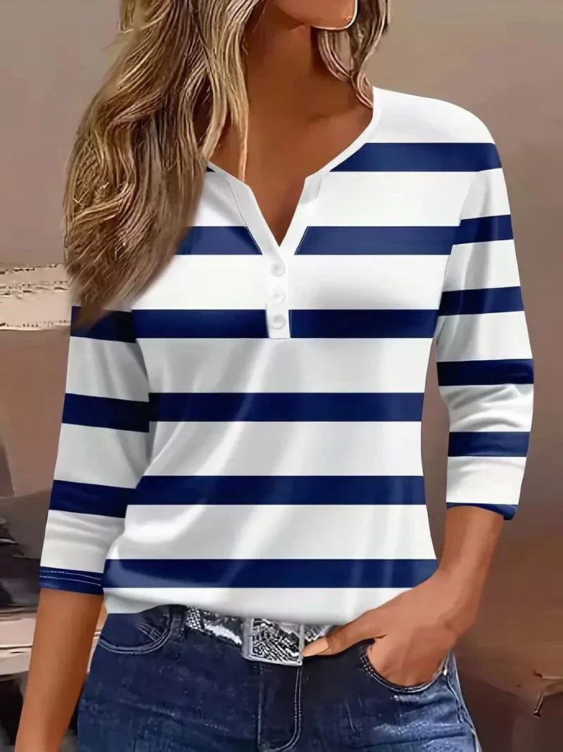  Female wearing a casual striped V-neck top on a plain background.
