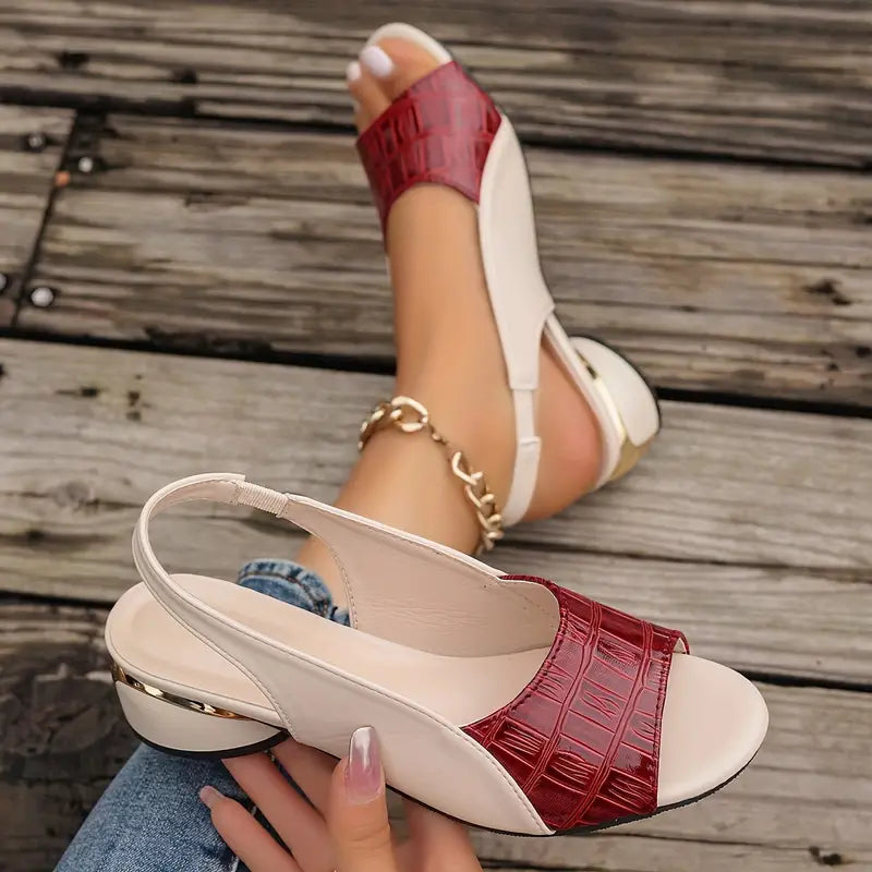 Woman in stylish open-toe sandals with a metallic heel accent.