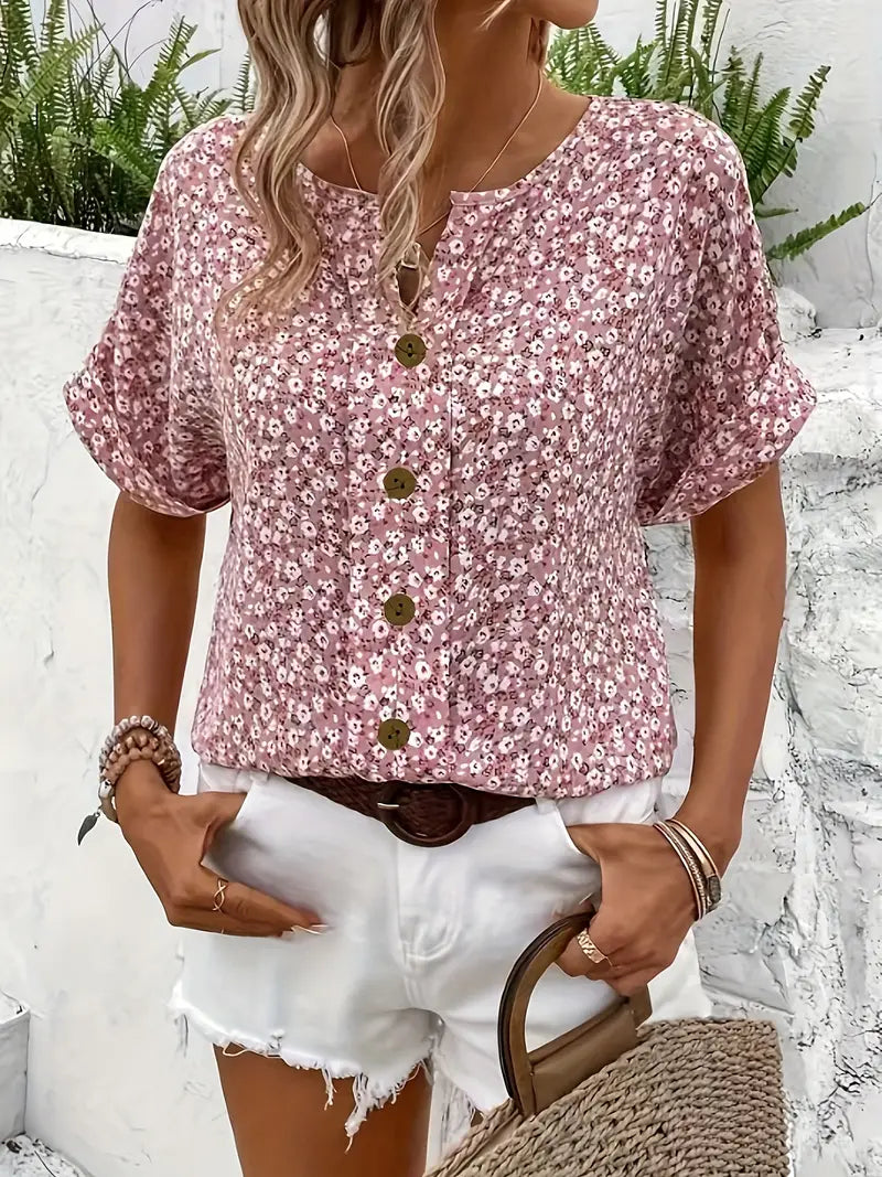  Woman wearing a casual floral blouse styled against a plain studio background.