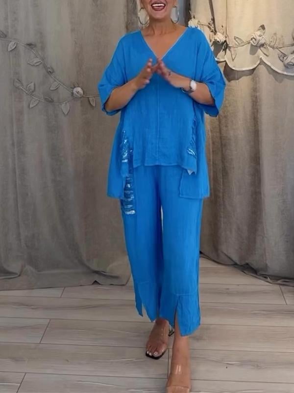 Female model styled in a coordinated summer co-ord set with flowing wide-leg trousers.