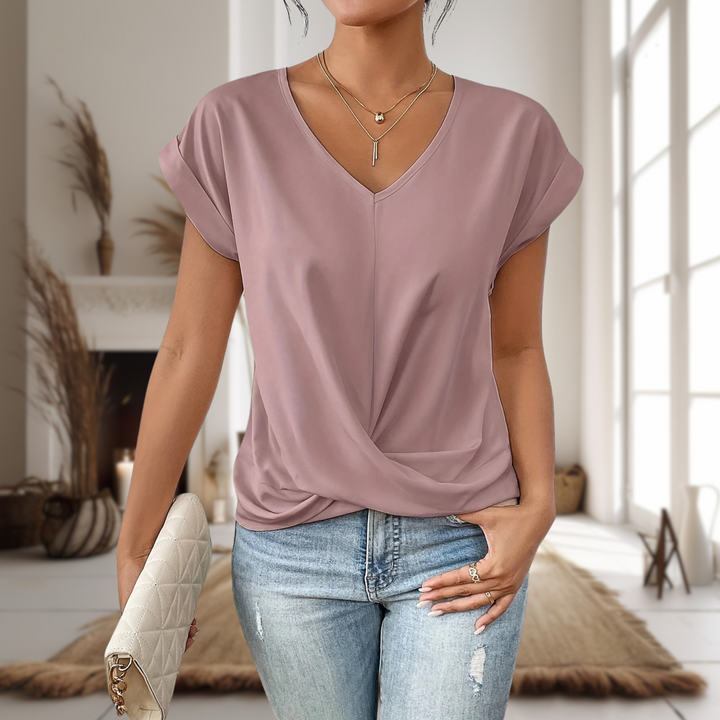  Female modelling a casual short sleeve top with a sweetheart neckline. 