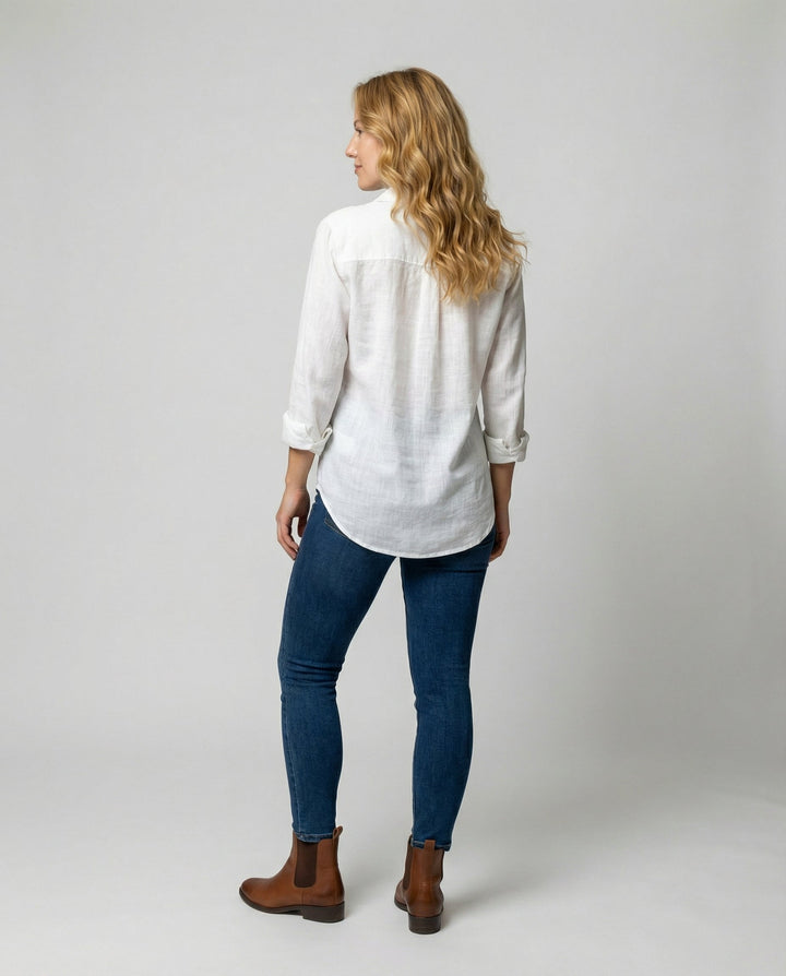 Female wearing a casual V-neck blouse on a plain background.